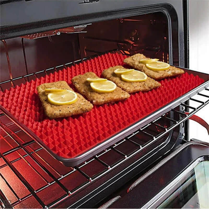 Non-Stick Silicone Cooking Mat with crispy food cooking in oven, featuring lemon slices on top.