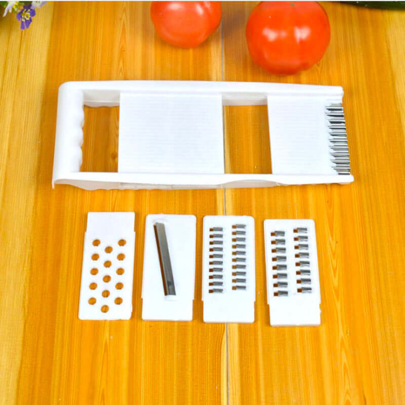Home Kitchen Multifunctional Grater set showcasing stainless steel and ABS slicer accessories with tomatoes.