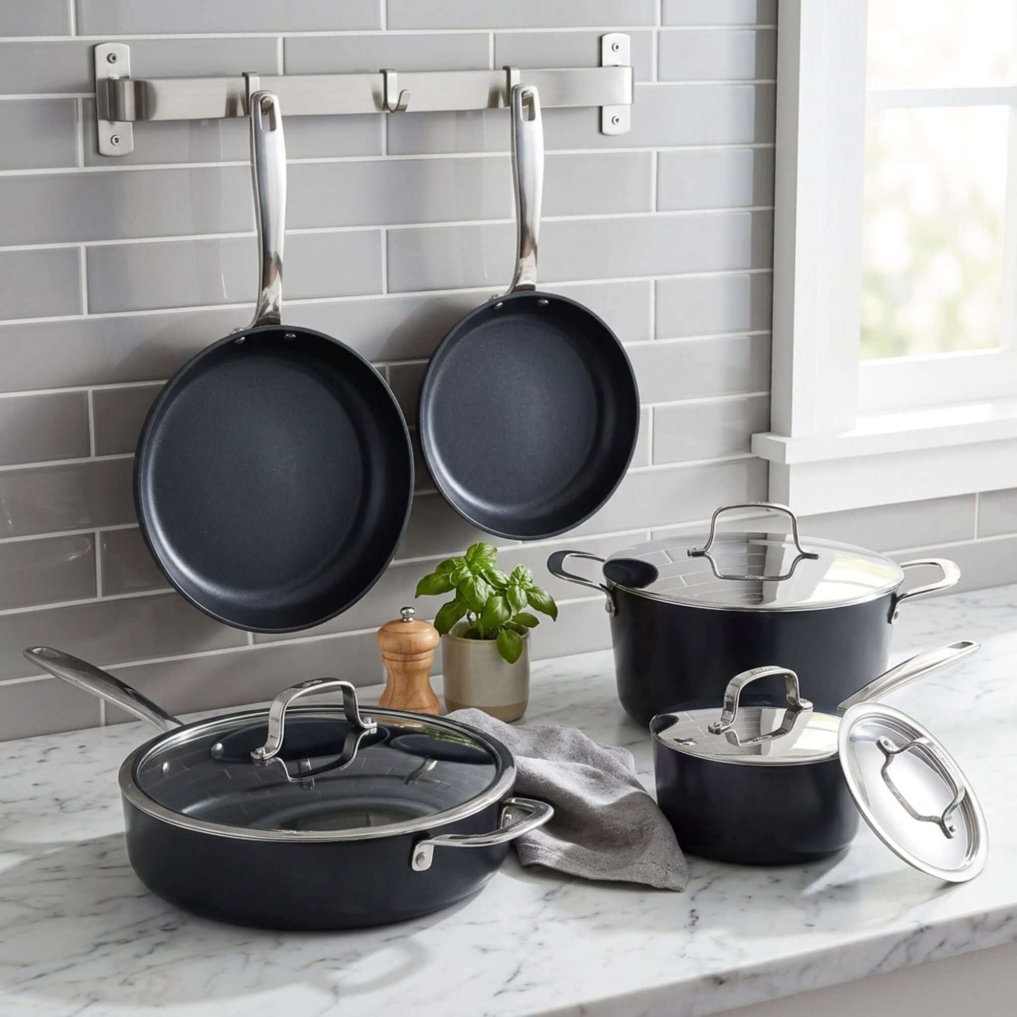 Ceramic Nonstick 12-Piece Set displayed in a modern kitchen, featuring frying pans and saucepans with glass lids on marble.
