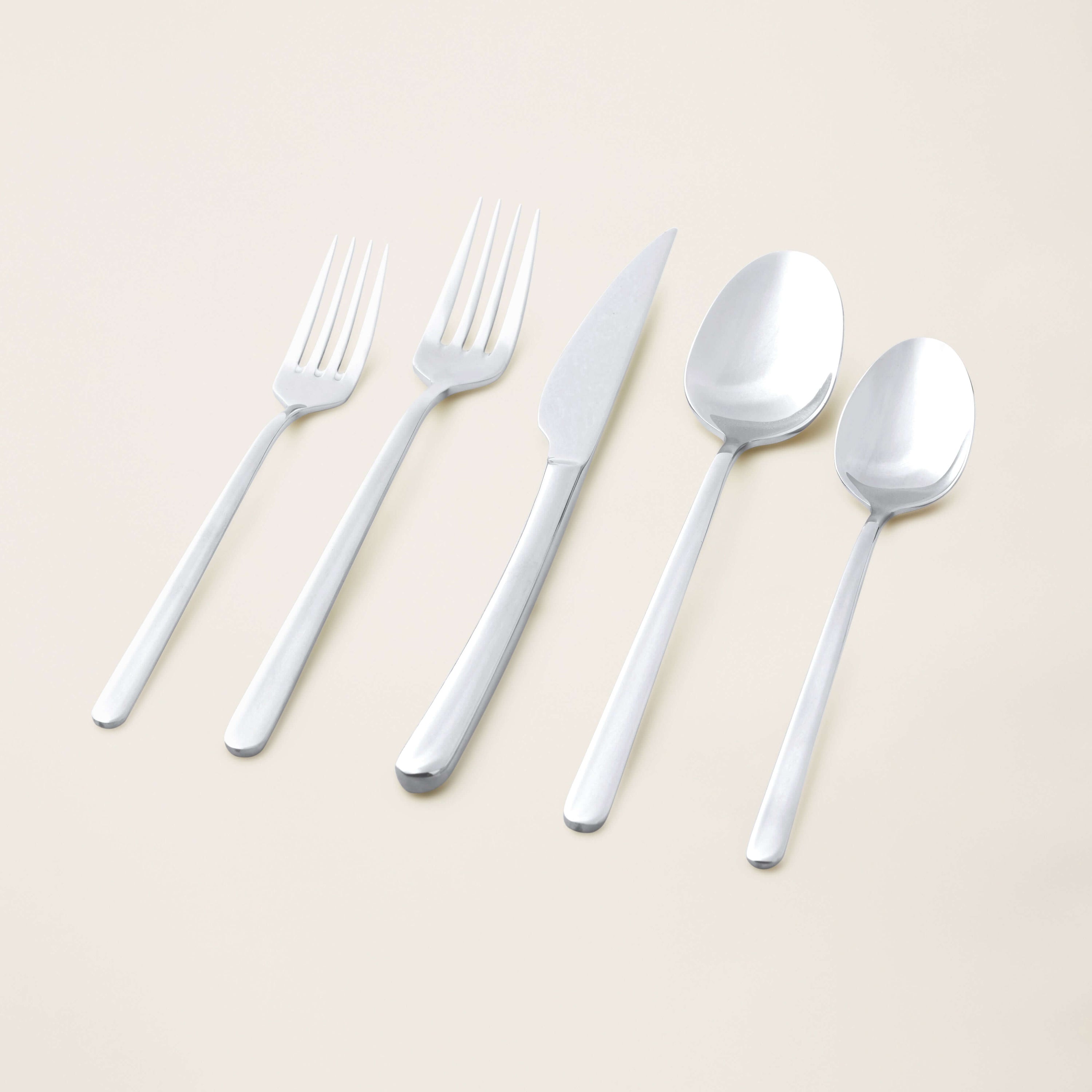 Emilia Mirror 20-Piece Flatware Set featuring a fork, knife, and spoon display on a neutral background.