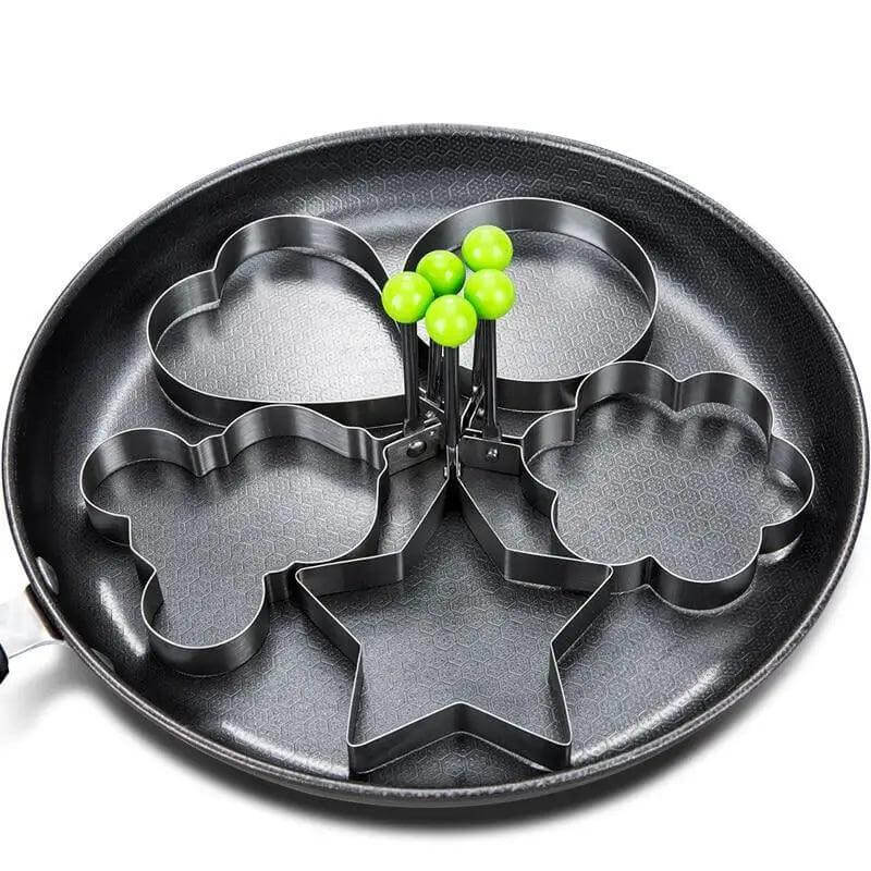 5Pcs stainless steel egg mold set in a frying pan for fun-shaped eggs and pancakes.