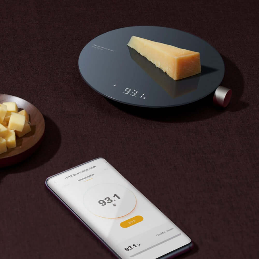 Smart Kitchen Scale displaying 93.1g weight measurement with smartphone app nearby.