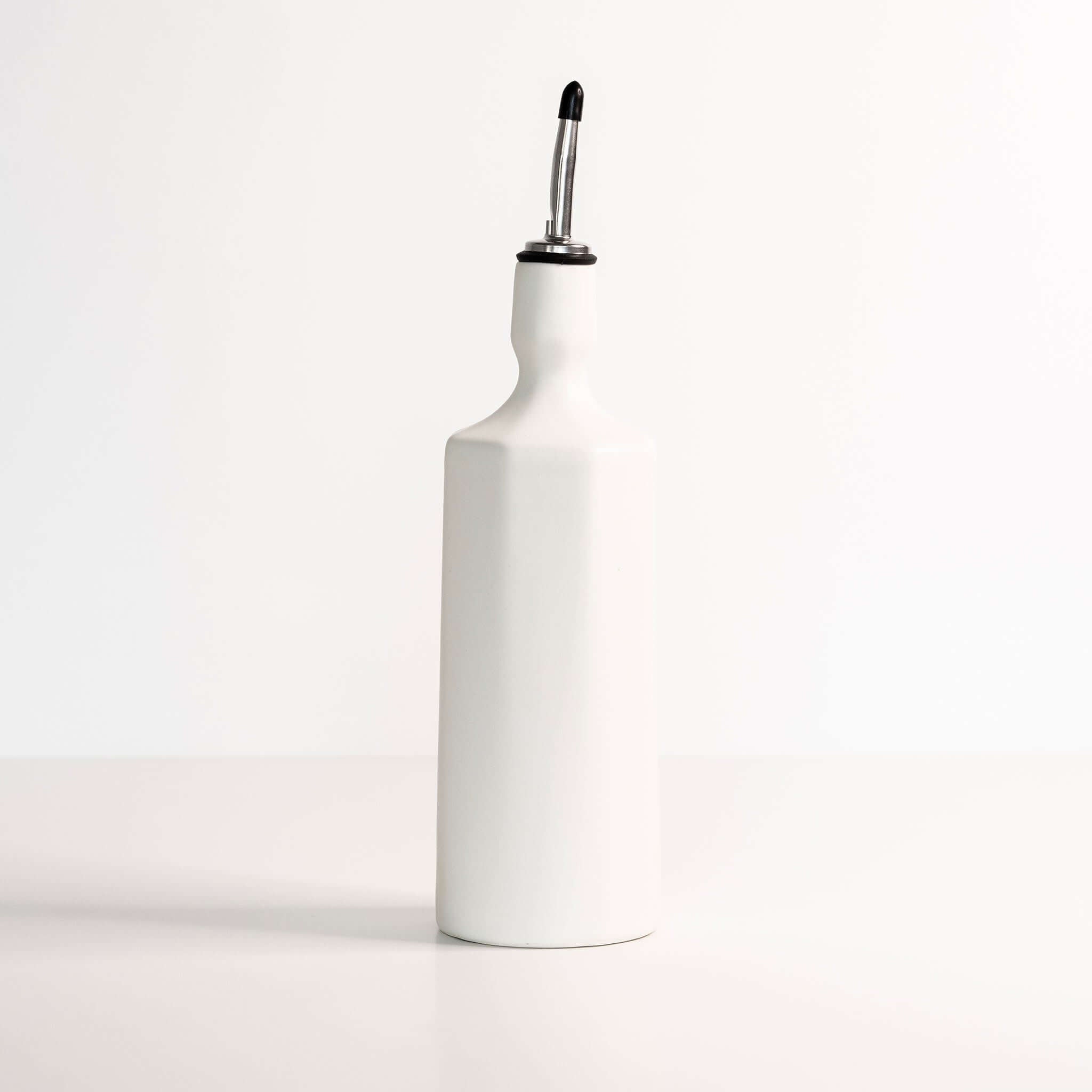 Ceramic olive oil dispenser in silk white color on a minimalist background, elegant for kitchen use.