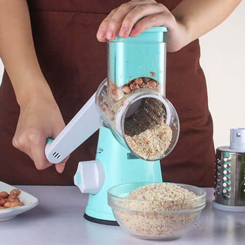Hands using a multifunctional mandoline slicer kitchen gadget to shred nuts into a bowl.
