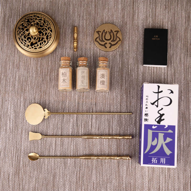 Pure copper incense set including incense burner, tools, and fragrance jars arranged on a textured surface.