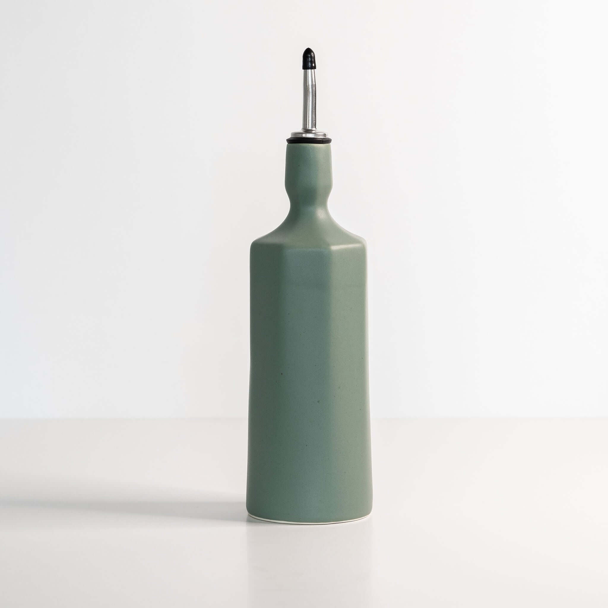 Elixir Porcelain Olive Oil Dispenser in Rosemary Green ceramic with sleek design for elegant oil storage.