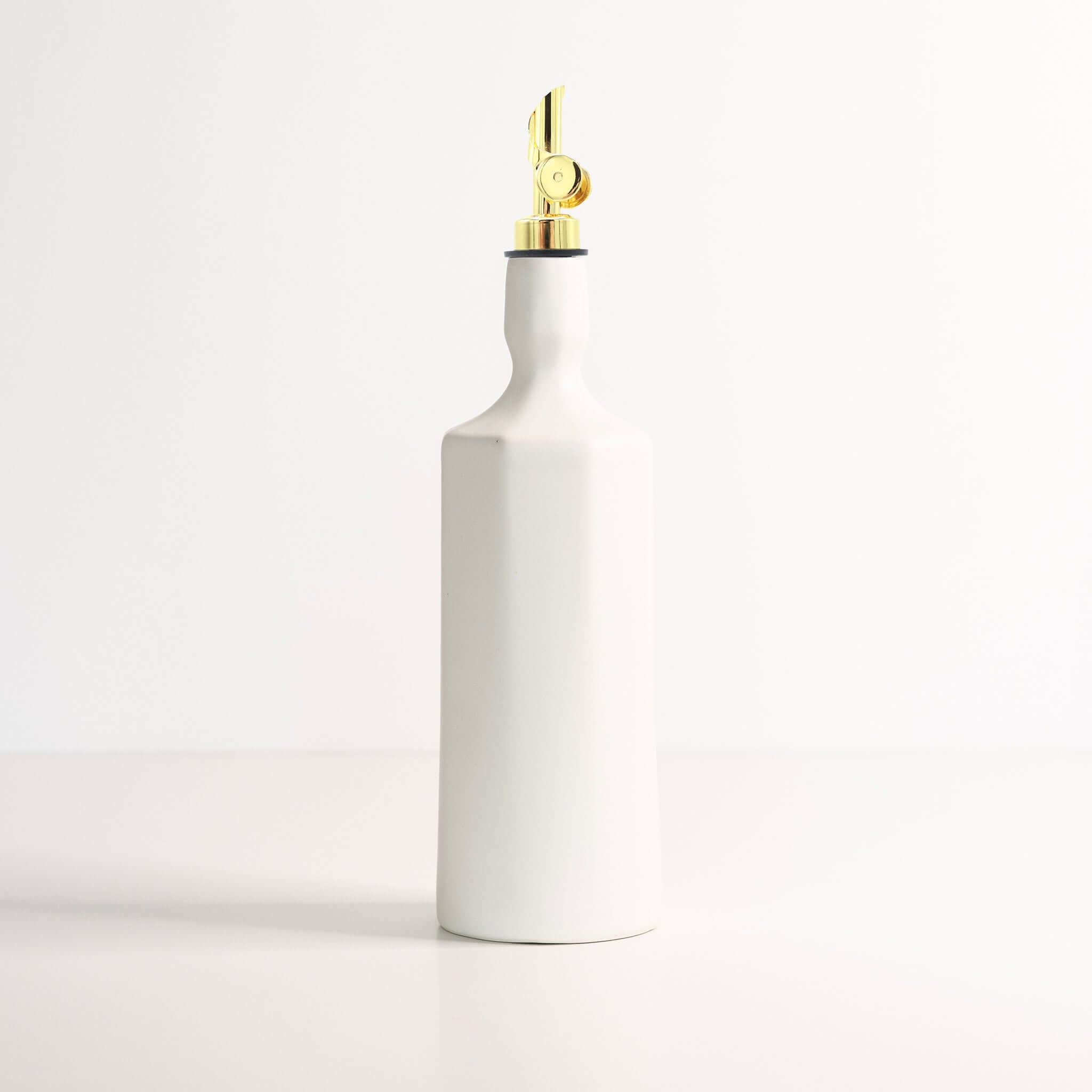 Elixir Porcelain ceramic olive oil dispenser with gold accent, perfect for stylish kitchens and dining
