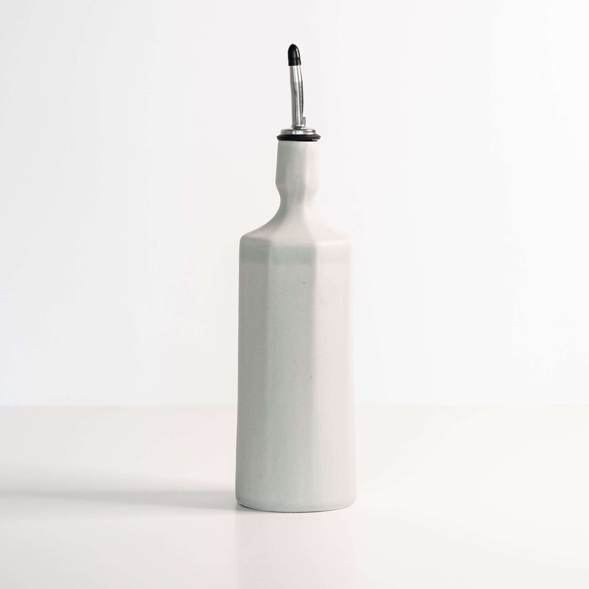 Elixir Porcelain Olive Oil Dispenser in smoke grey ceramic with a sleek design and pour spout.