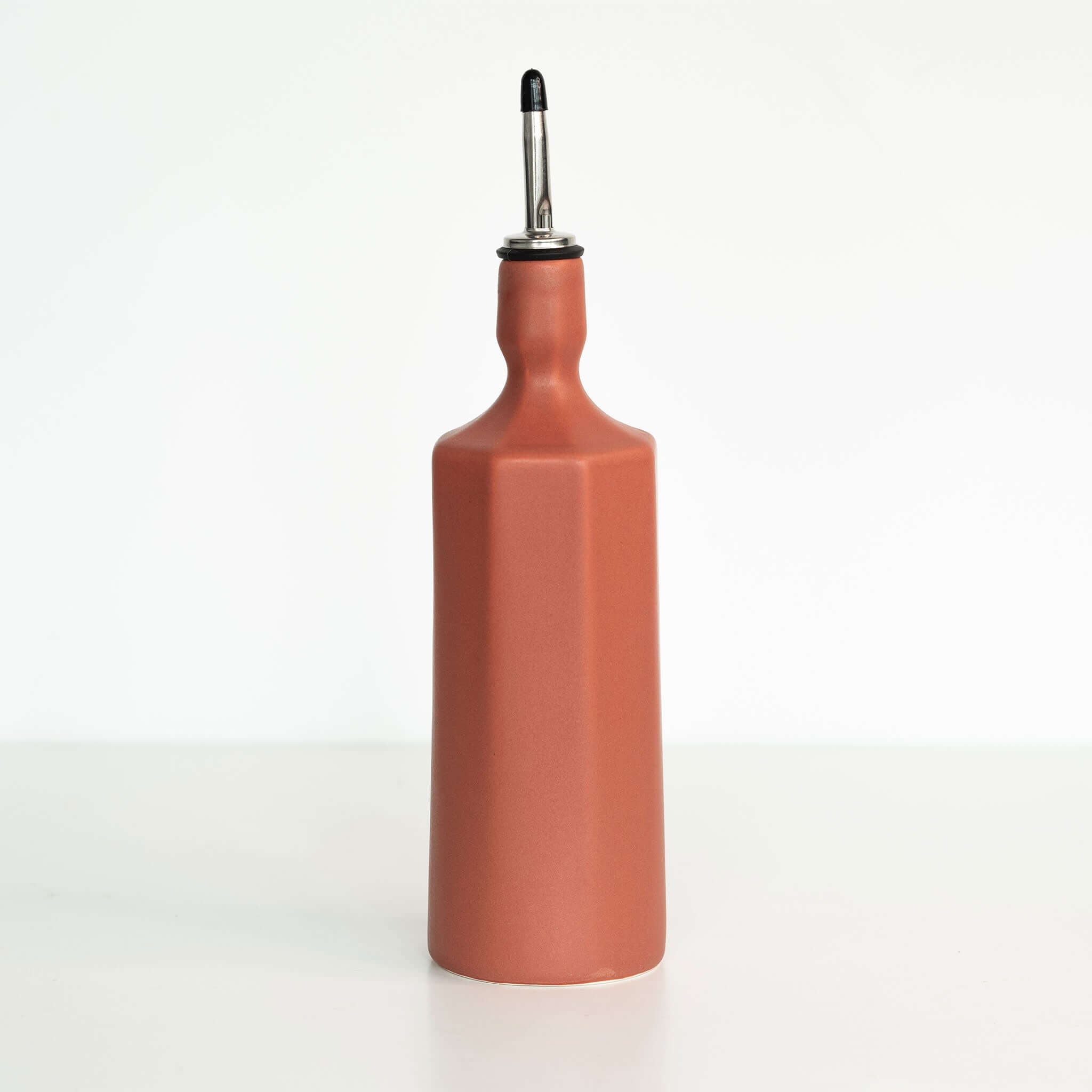 Elixir Porcelain Olive Oil Dispenser in terracotta red, elegant ceramic design with a smooth finish for kitchen use.