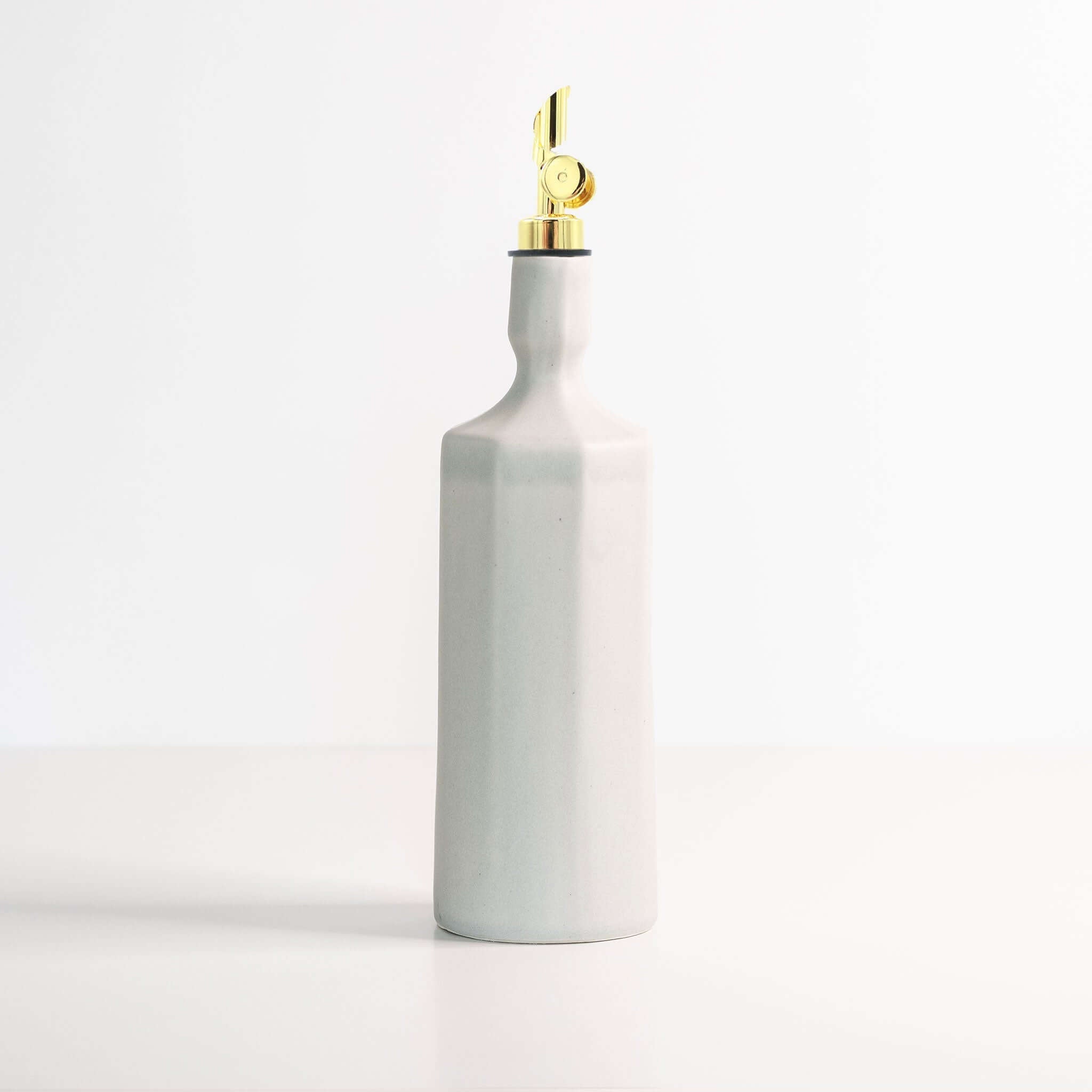 Elixir Porcelain Olive Oil Dispenser in elegant gray ceramic with gold accent for oil storage and pouring.