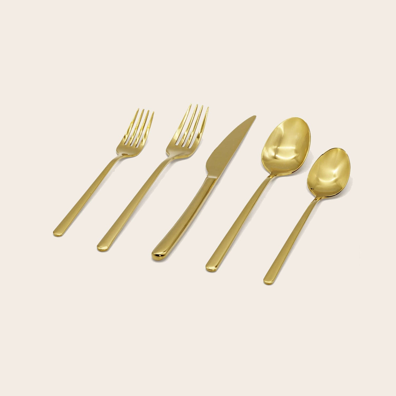 Emilia Mirror 20-Piece Flatware Set featuring elegant gold utensils, including forks, knife, and spoons.