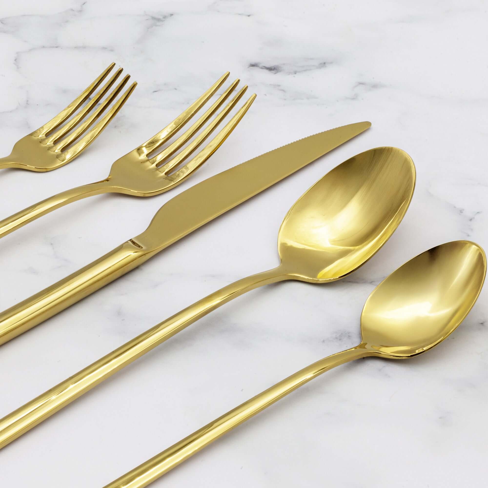 Emilia Mirror 20-Piece Flatware Set displayed with golden forks, knife, and spoons on marble background.