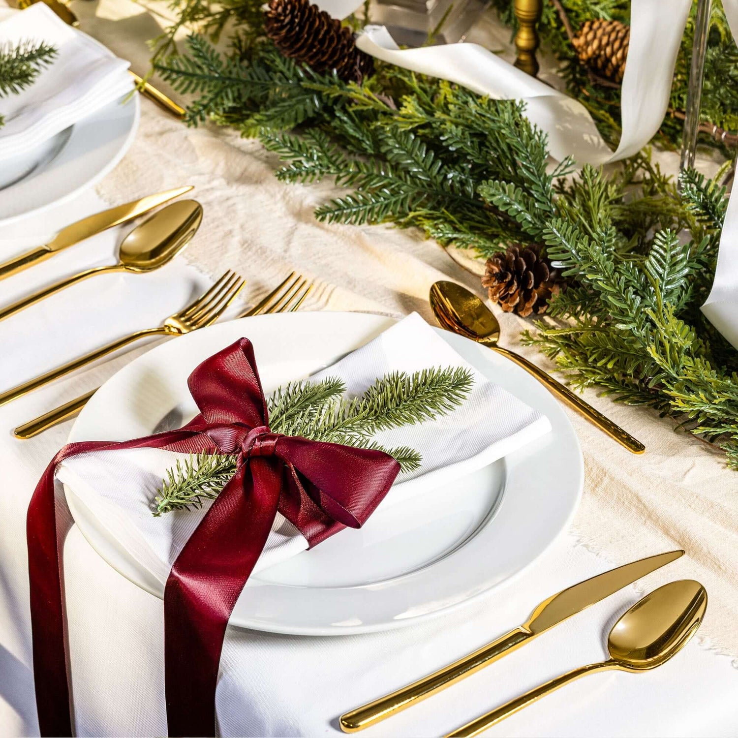 Emilia Mirror 20-Piece Flatware Set elegantly displayed on a festive dining table with decorative elements.