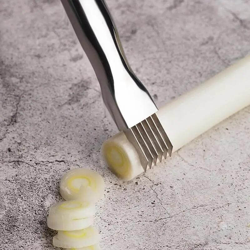 Stainless SteelcVegetable Cutter slicing scallions on a countertop for precise vegetable preparation.