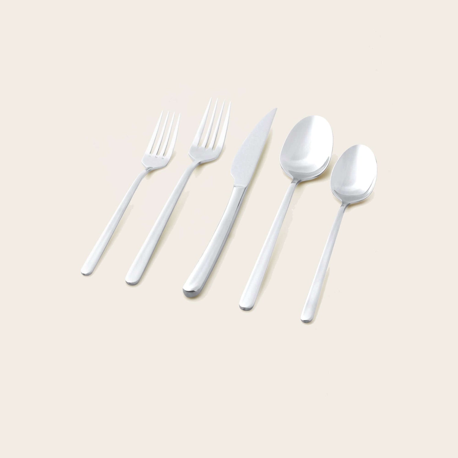 Emilia Mirror 20-Piece Flatware Set displayed on a neutral background, showcasing a fork, knife, and spoons.