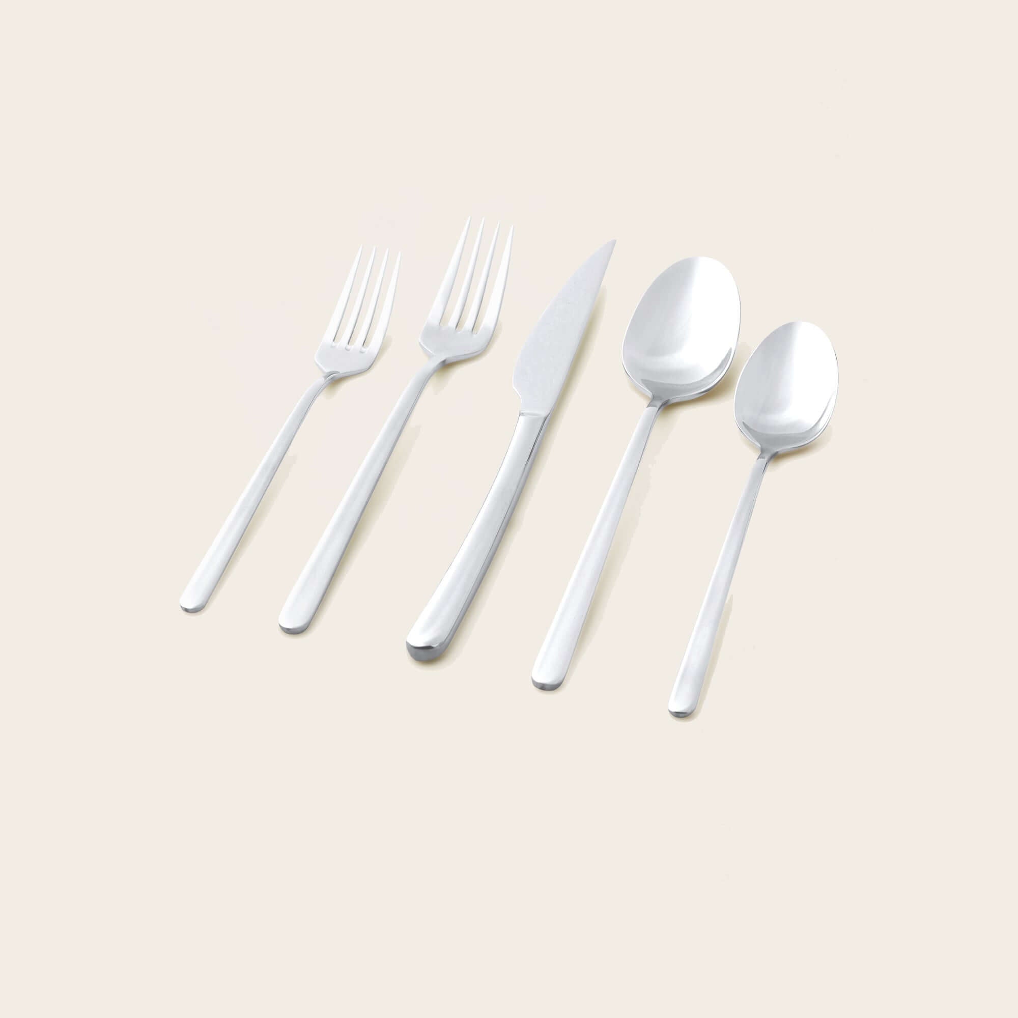Emilia Mirror 20-Piece Flatware Set displayed on a neutral background, showcasing a fork, knife, and spoons.